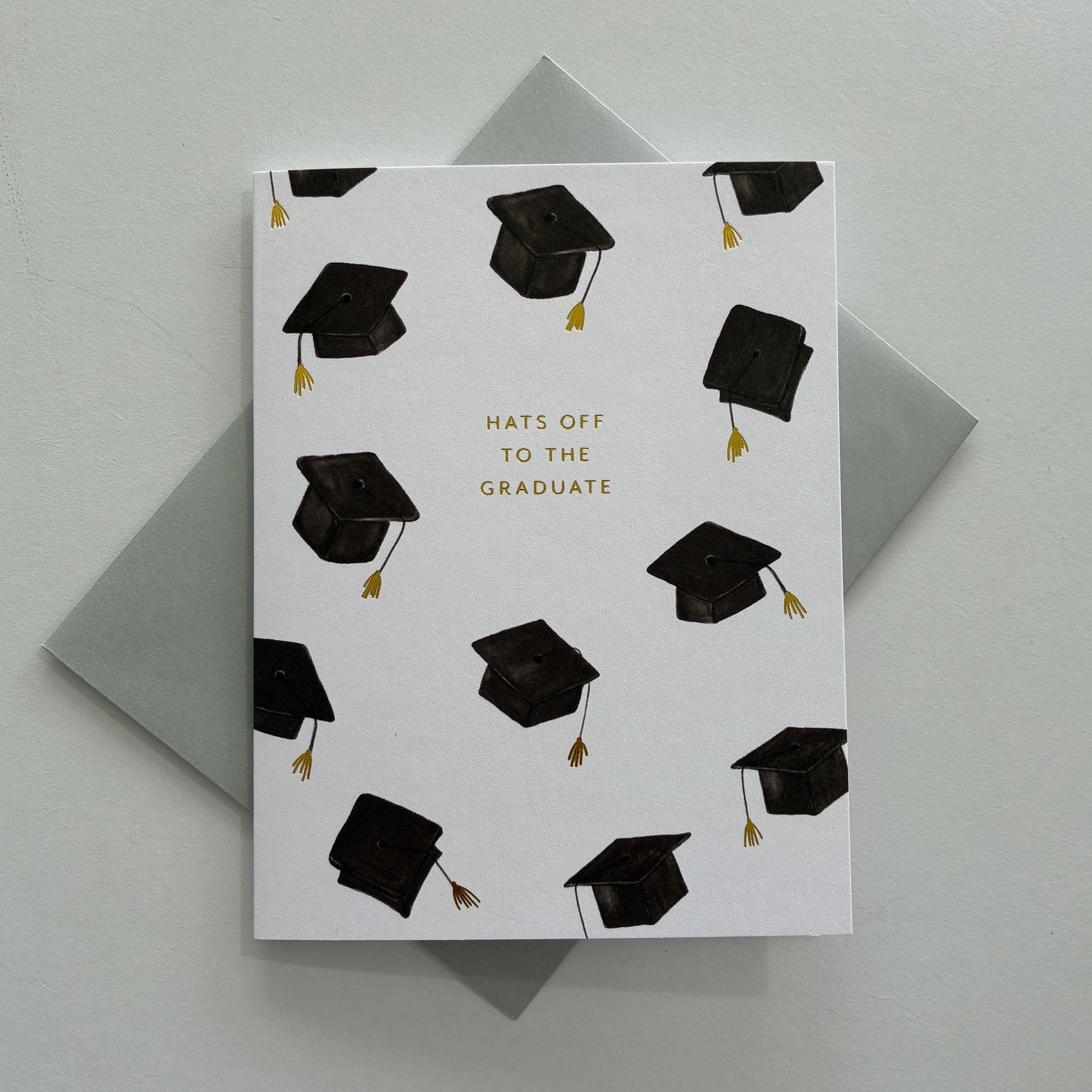 Graduation-themed card with black caps and 'Hats Off to the Graduate' text on a white background.
