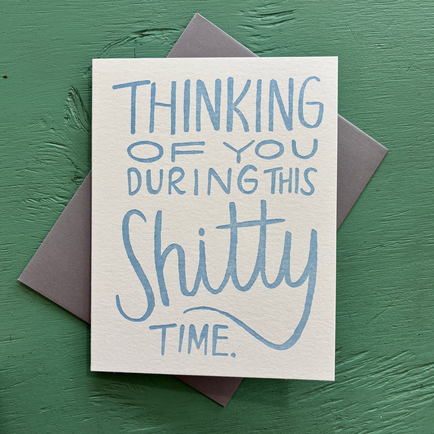 Card with blue text 'Thinking of you during this shitty time' on a green background