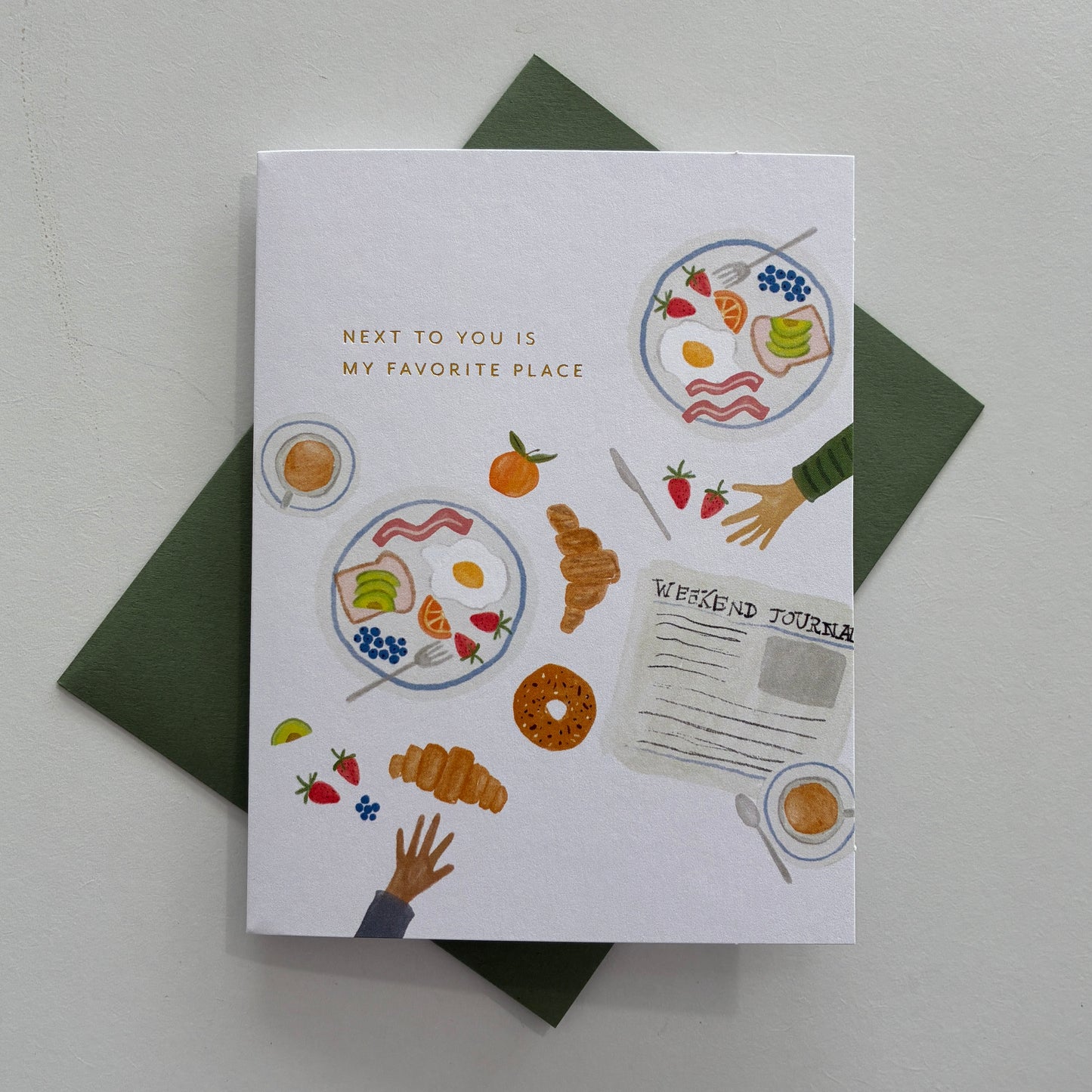 Card with illustrations of food and text saying "next to you is my favorite place" on a white background