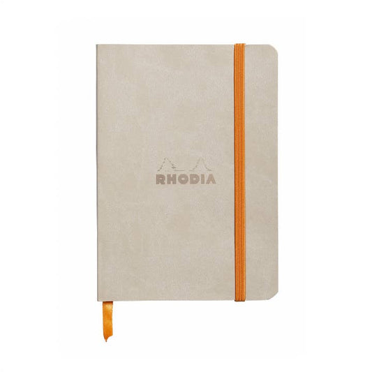 Beige notebook with orange strap and Rhodia branding on a white background