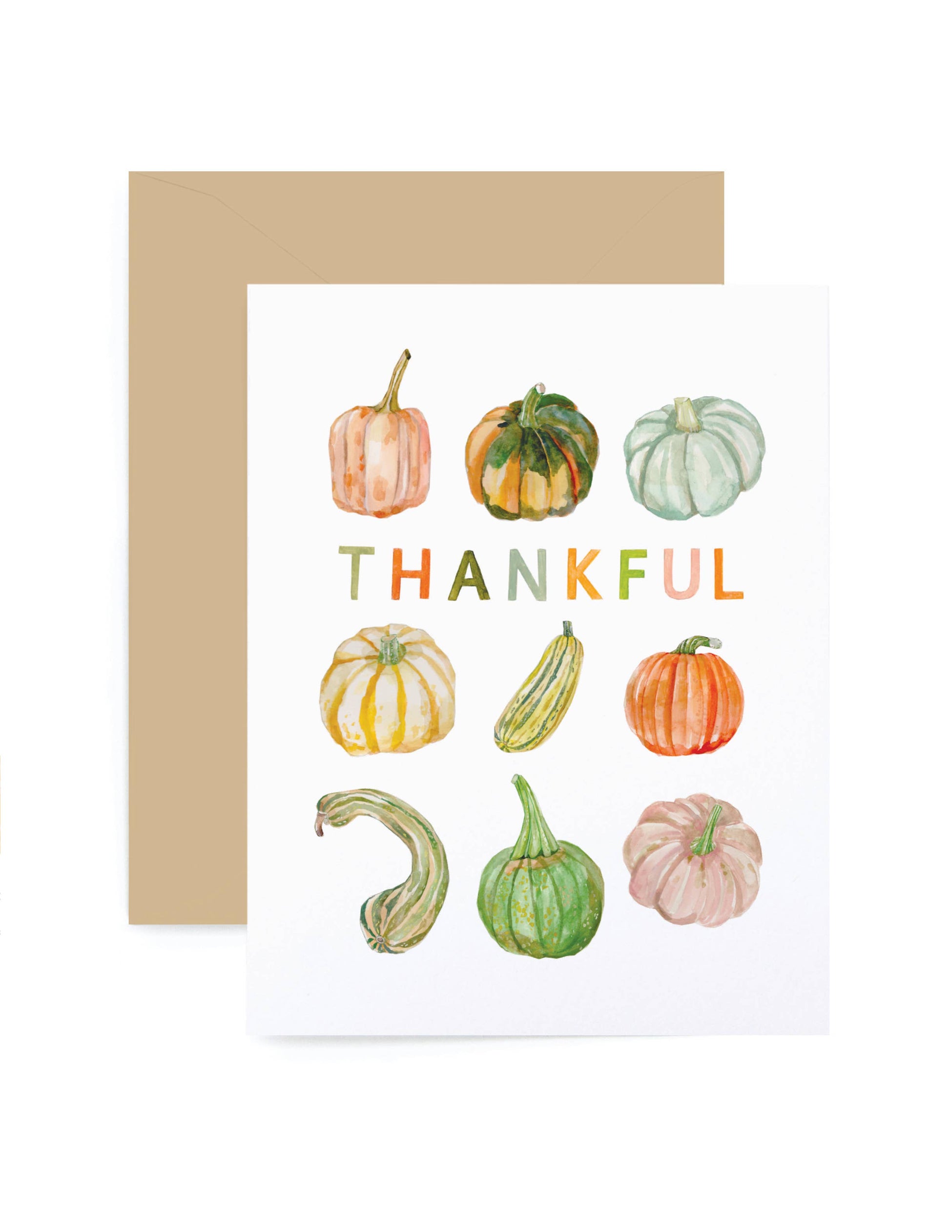 A white greeting card with a watercolor illustration of various pumpkins and gourds, with the word 'THANKFUL' printed in the center. A kraft brown envelope is placed behind the card on a white background.