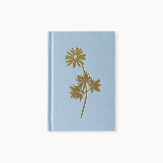 Light blue notebook with gold floral design on a white background