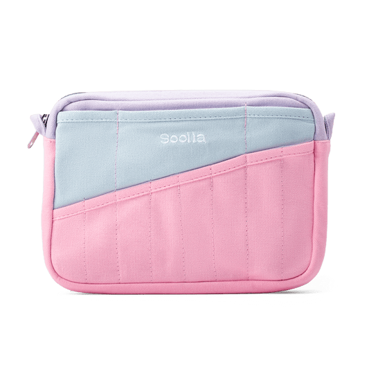 A small rectangular pouch with a diagonal color-block design in pastel pink and light blue, featuring a lavender zipper closure and the brand name 'soolla' printed in white on the front.