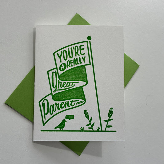 Greeting card with green "you're a really great parent" text and illustrations on a white background
