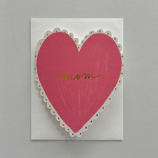 Card with a pink heart and 'mom' written on it against a gray background