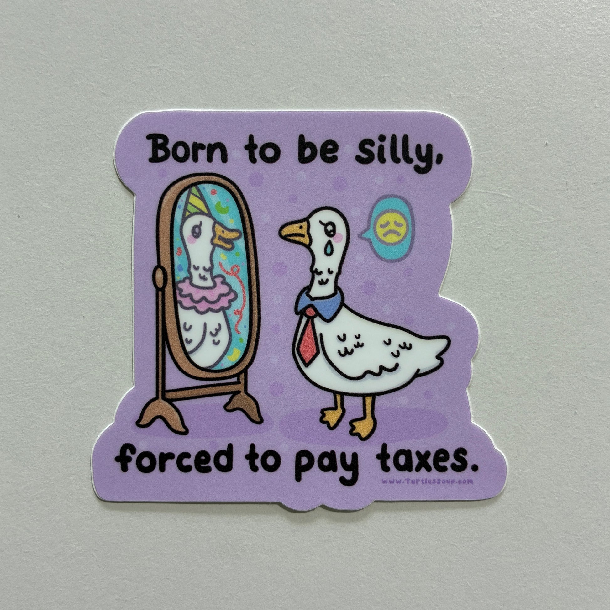 A sticker with a goose drawing and text that says “born to be silly, forced to pay taxes” on a gray background