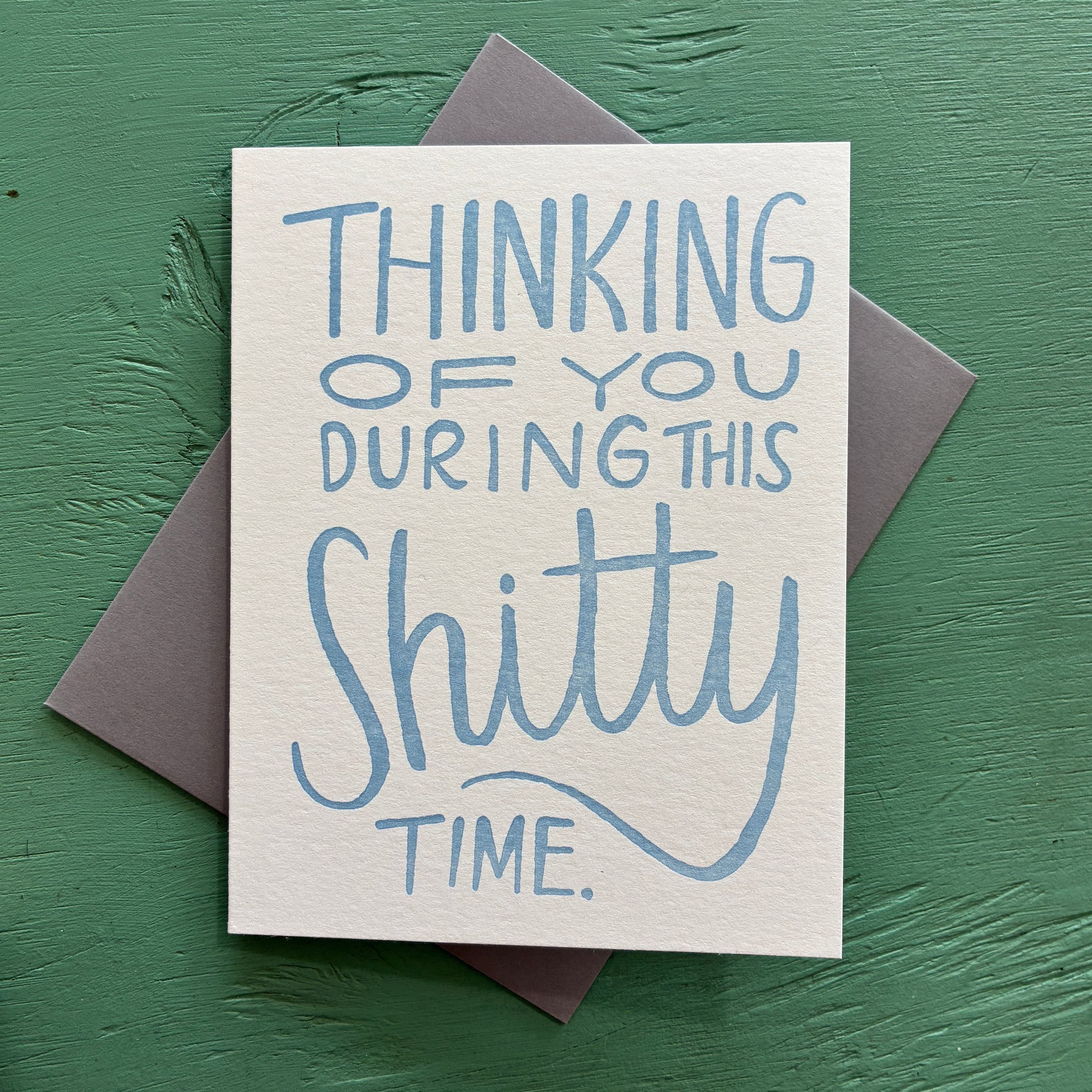 Card with blue text 'Thinking of you during this shitty time' on a green background