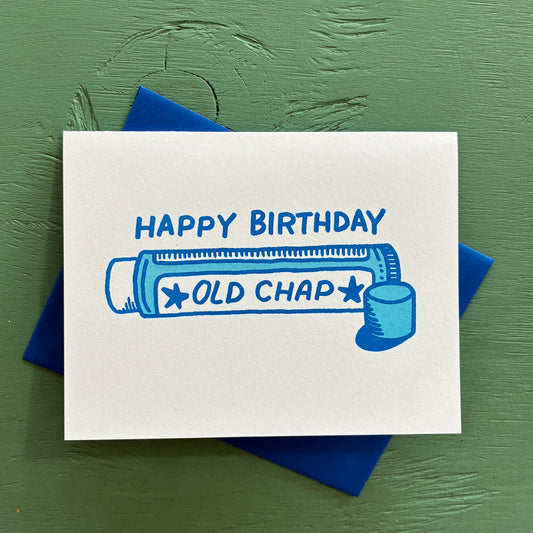 Birthday card with 'Happy Birthday Old Chap' text and illustration on a green background