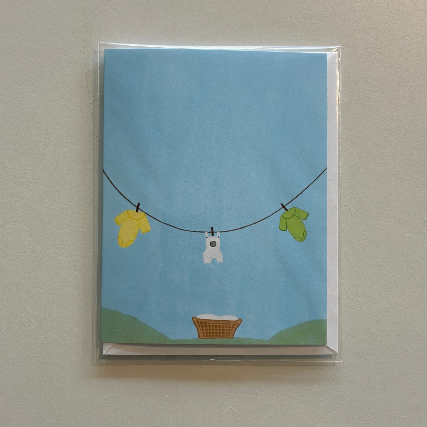 Illustration of baby onesies hanging on a clothesline