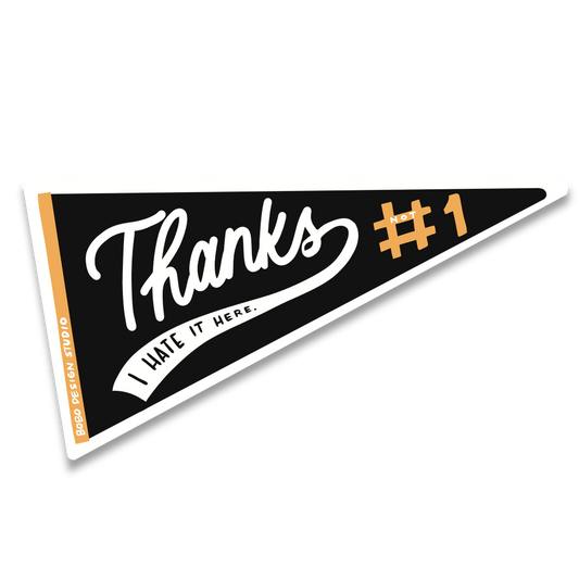 A black triangular pennant-style sticker with a white border, featuring the words 'Thanks I hate it here’