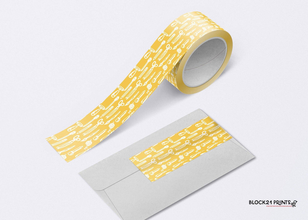 Yellow patterned tape on a white background with an envelope